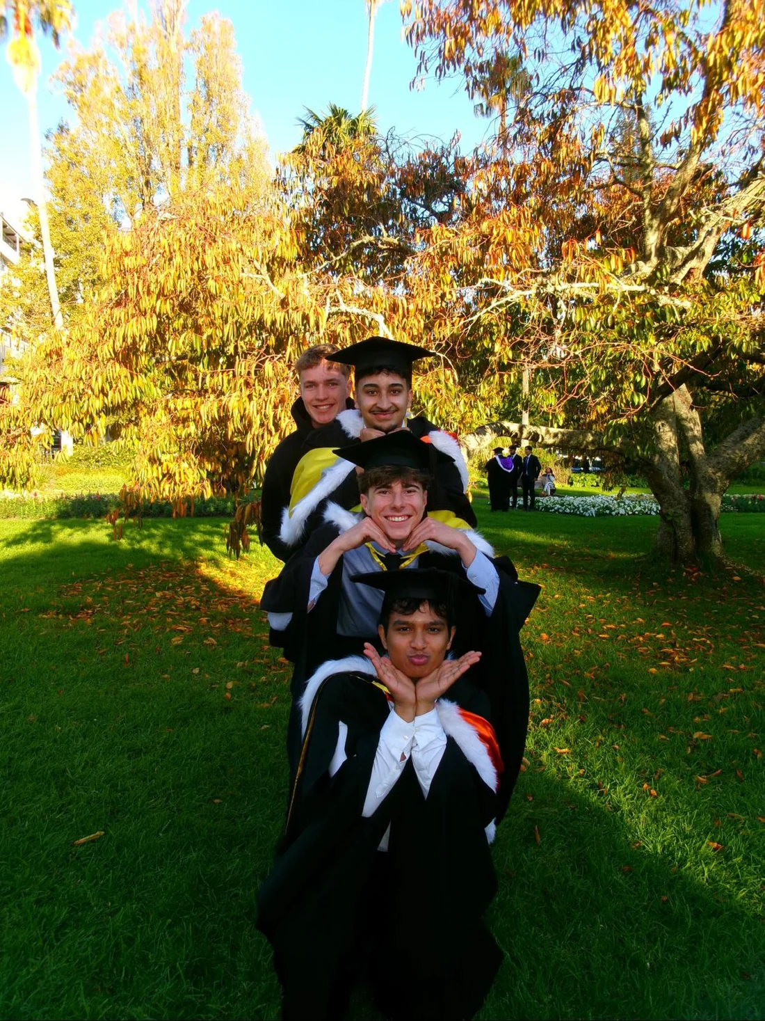 Aaditha and friends at graduation in gowns